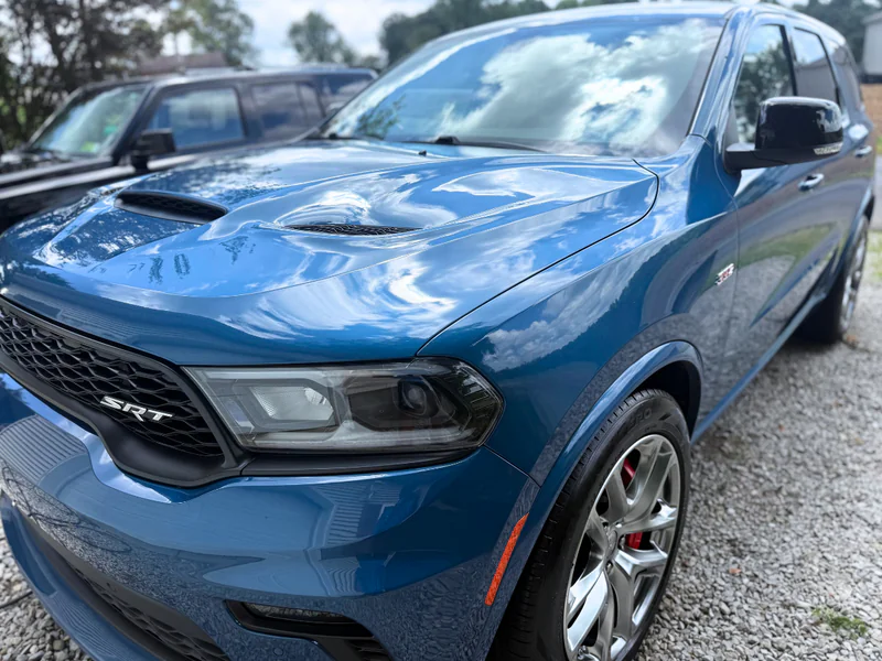 Professional exterior detailing service - pristine blue Dodge SRT showing paint enhancement and protection