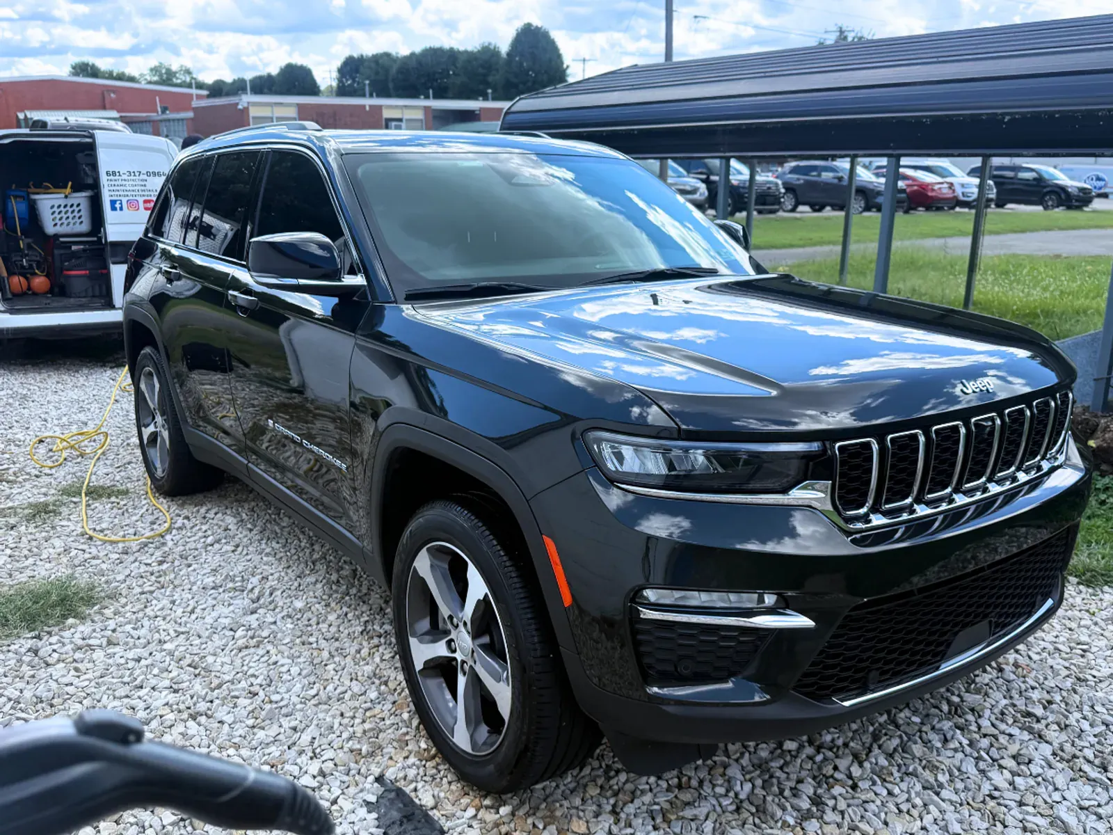 Black Jeep Grand Cherokee passenger angle showing flawless paint