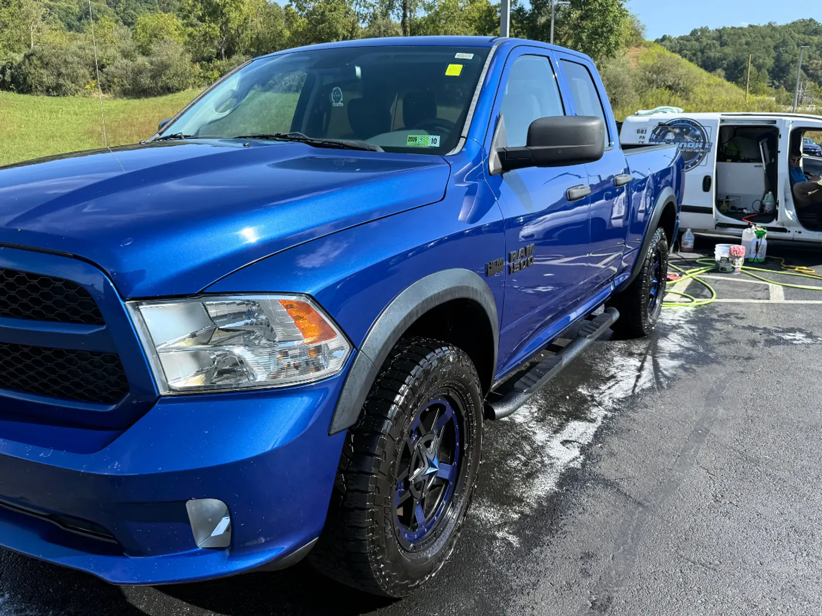 Blue Ram 1500 showing vibrant paint restoration.