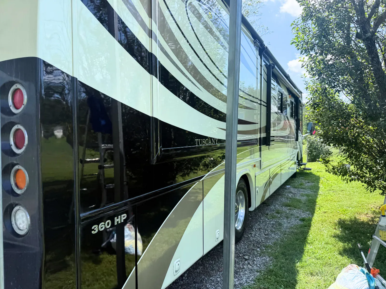 RV rear passenger side angle showing professional detailing results