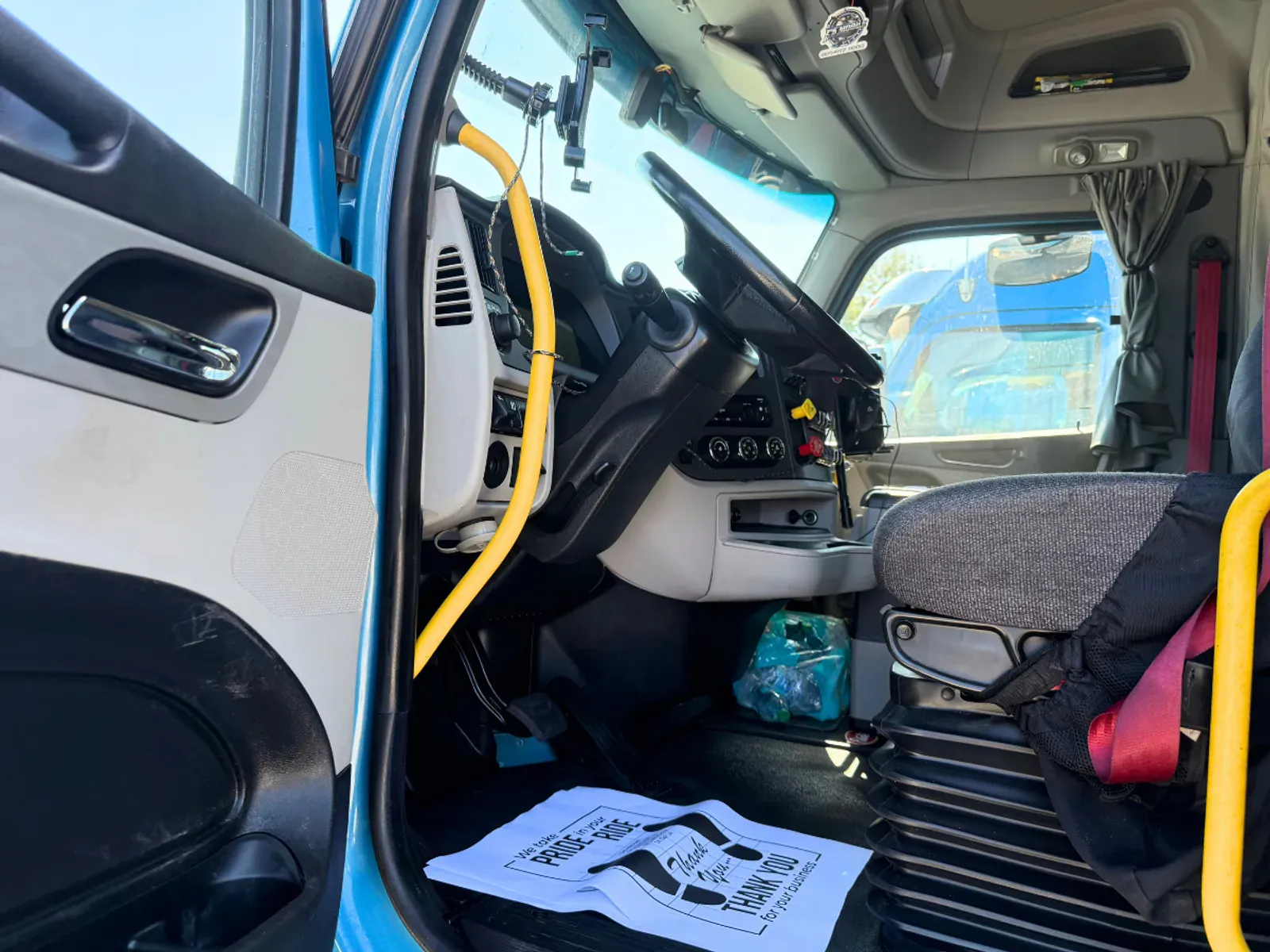 Semi-truck driver side cabin area with spotless interior detailing